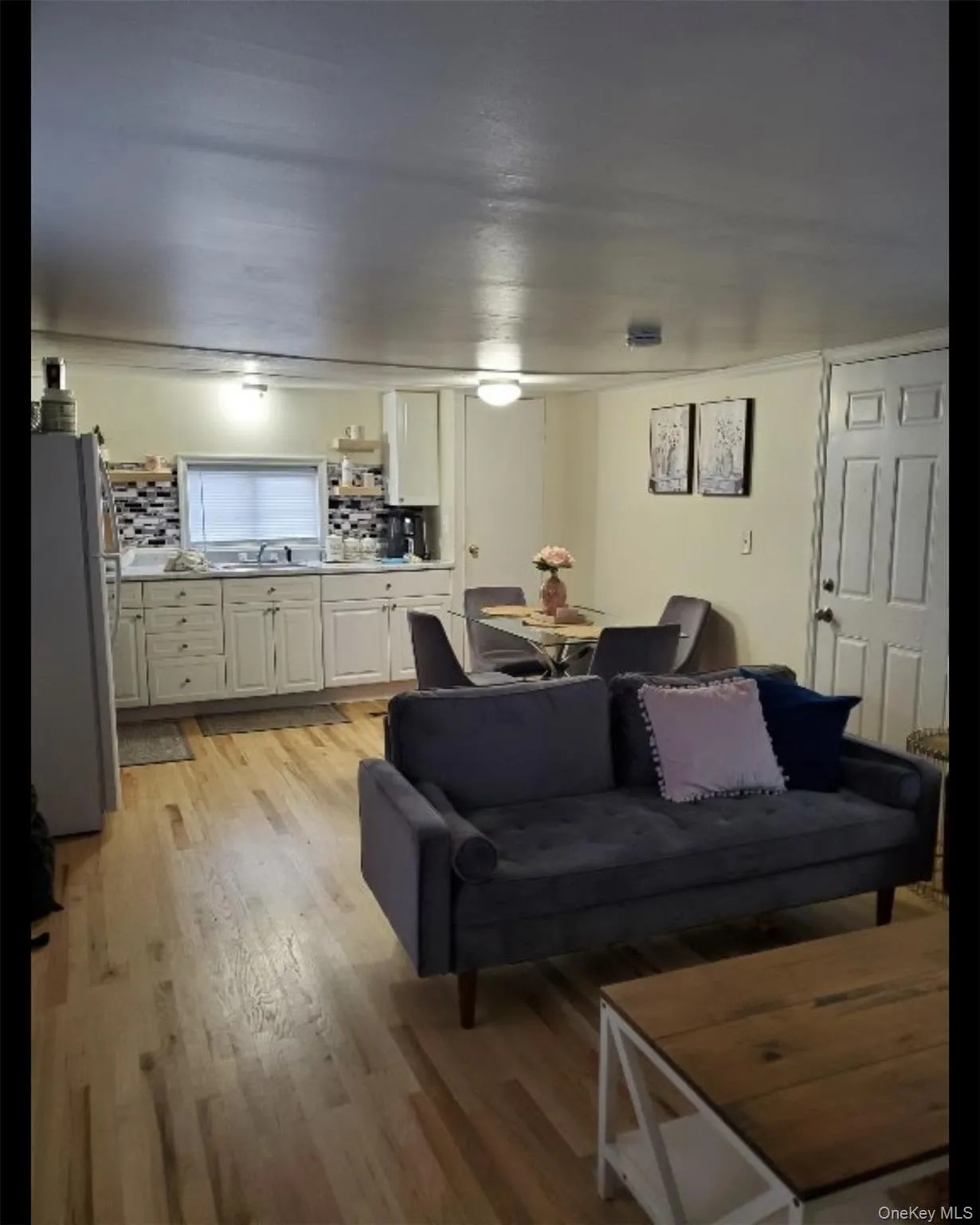 Living area with light wood-type flooring Living area with light wood-type flooring