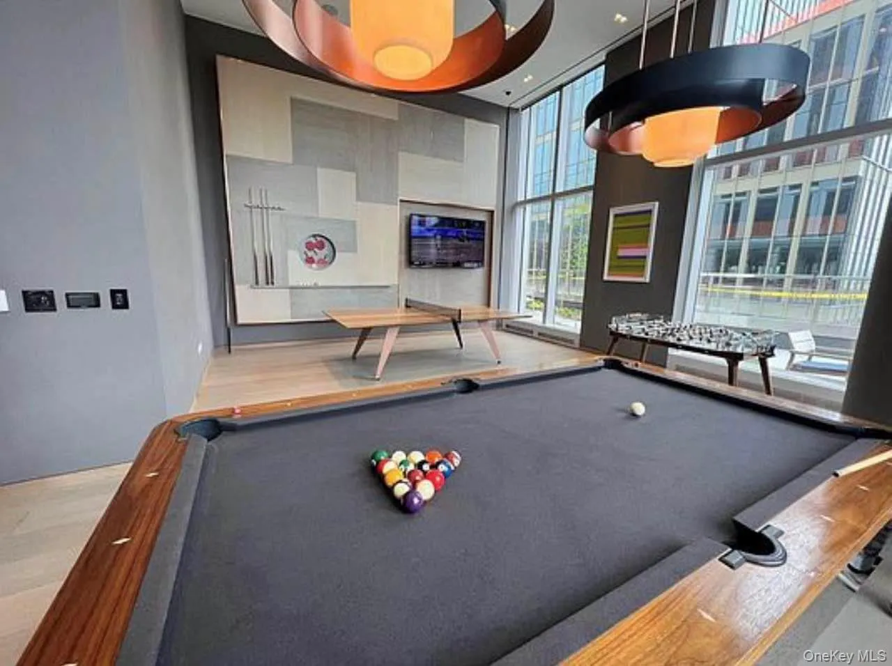 Game room with pool table, expansive windows, and a towering ceiling Game room with pool table, expansive windows, and a towering ceiling