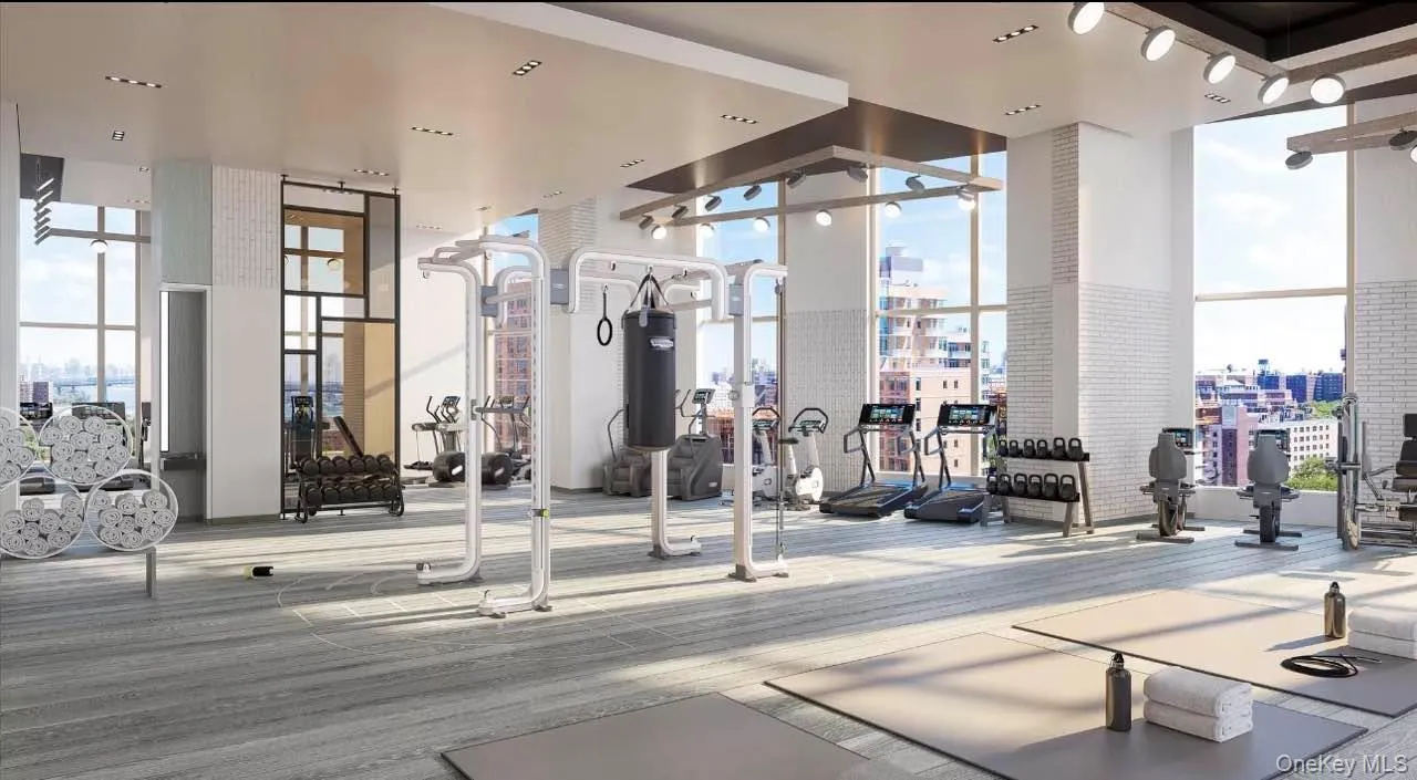Exercise room featuring expansive windows and a city view Exercise room featuring expansive windows and a city view