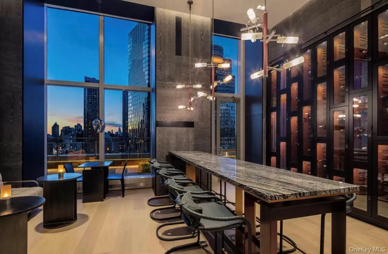 Wine room featuring light wood-type flooring and wine cooler Wine room featuring light wood-type flooring and wine cooler