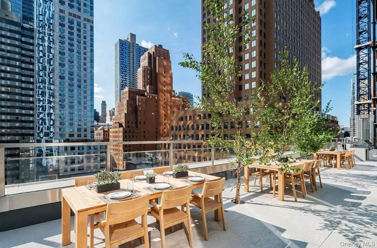 View of patio / terrace with outdoor dining area and a city view View of patio / terrace with outdoor dining area and a city view