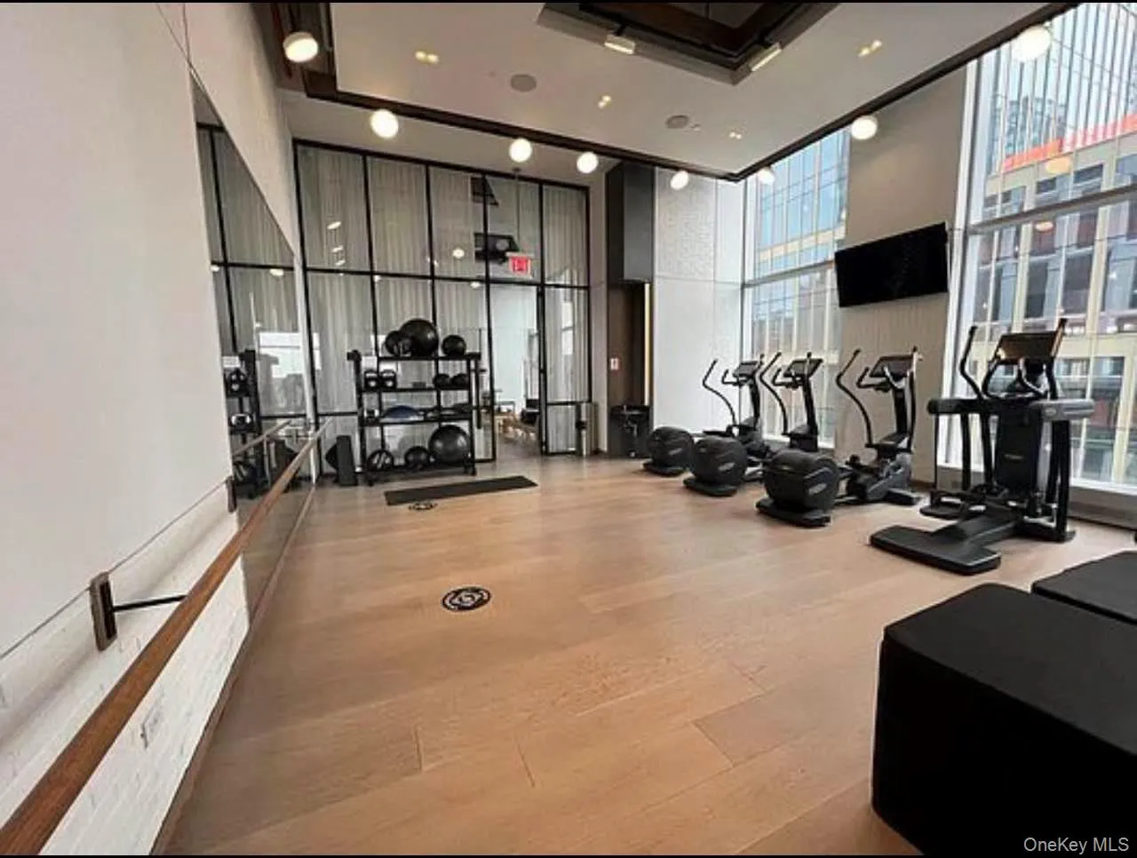 Workout area featuring a wall of windows and a high ceiling Workout area featuring a wall of windows and a high ceiling