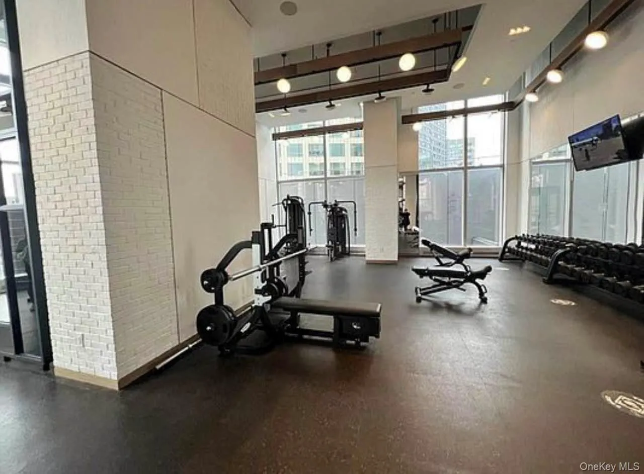Gym with a towering ceiling and expansive windows Gym with a towering ceiling and expansive windows