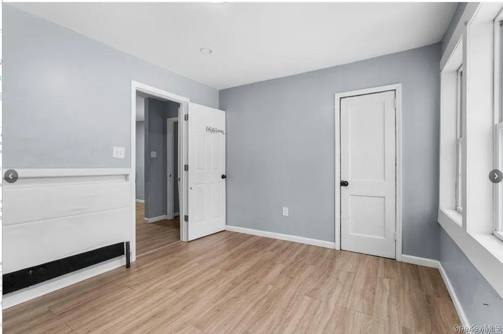 Unfurnished bedroom featuring light wood-style flooring and baseboards Unfurnished bedroom featuring light wood-style flooring and baseboards