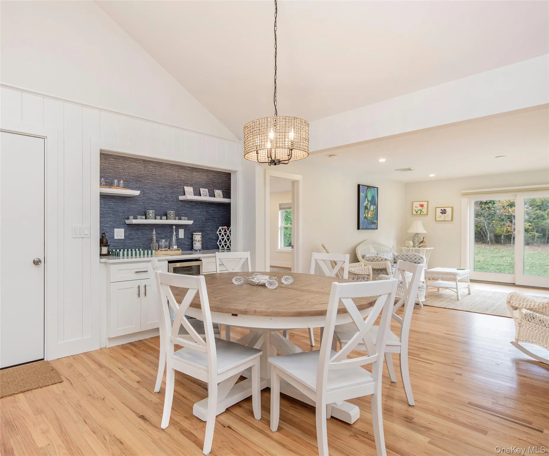Dining space featuring vaulted ceiling, a chandelier, light wood finished floors, and recessed lighting Dining space featuring vaulted ceiling, a chandelier, light wood finished floors, and recessed lighting