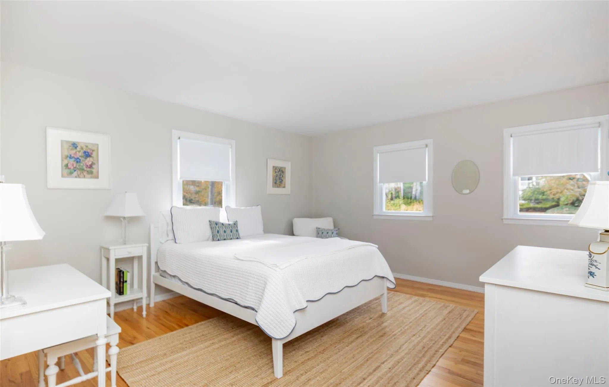 Bedroom with light wood finished floors and baseboards Bedroom with light wood finished floors and baseboards