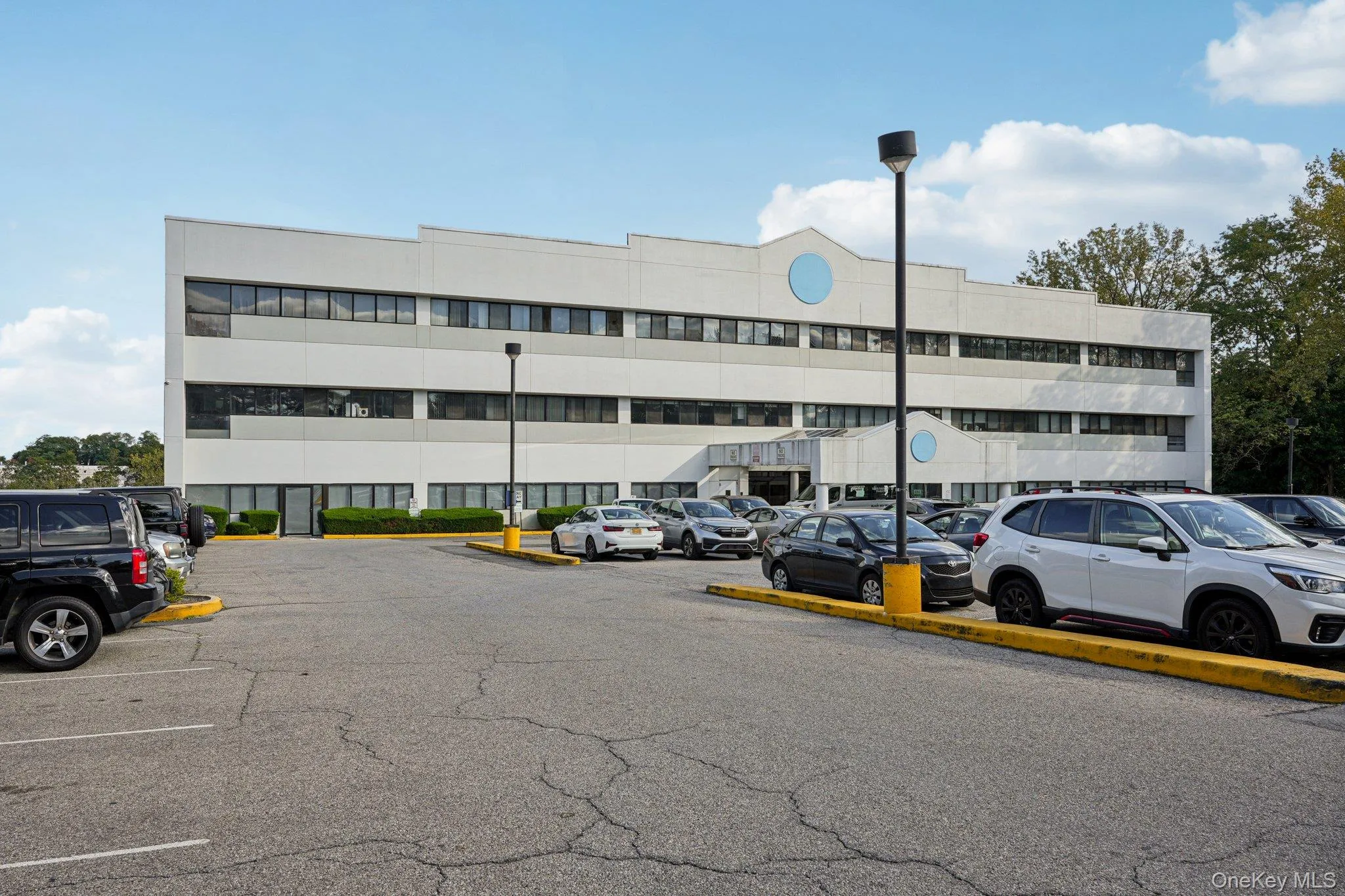 View of apartment building / complex featuring uncovered parking View of apartment building / complex featuring uncovered parking