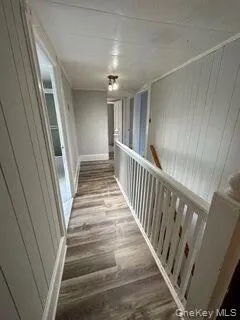 Hall with dark wood finished floors and wood walls Hall with dark wood finished floors and wood walls