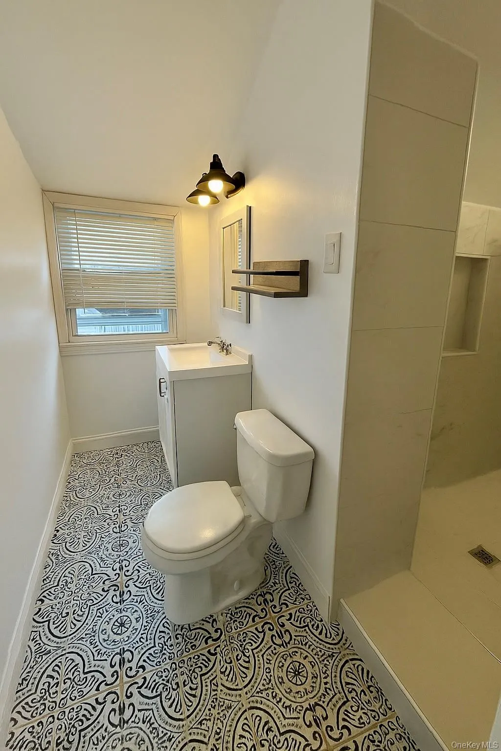 Bathroom with vanity, a shower, and light tile patterned flooring Bathroom with vanity, a shower, and light tile patterned flooring