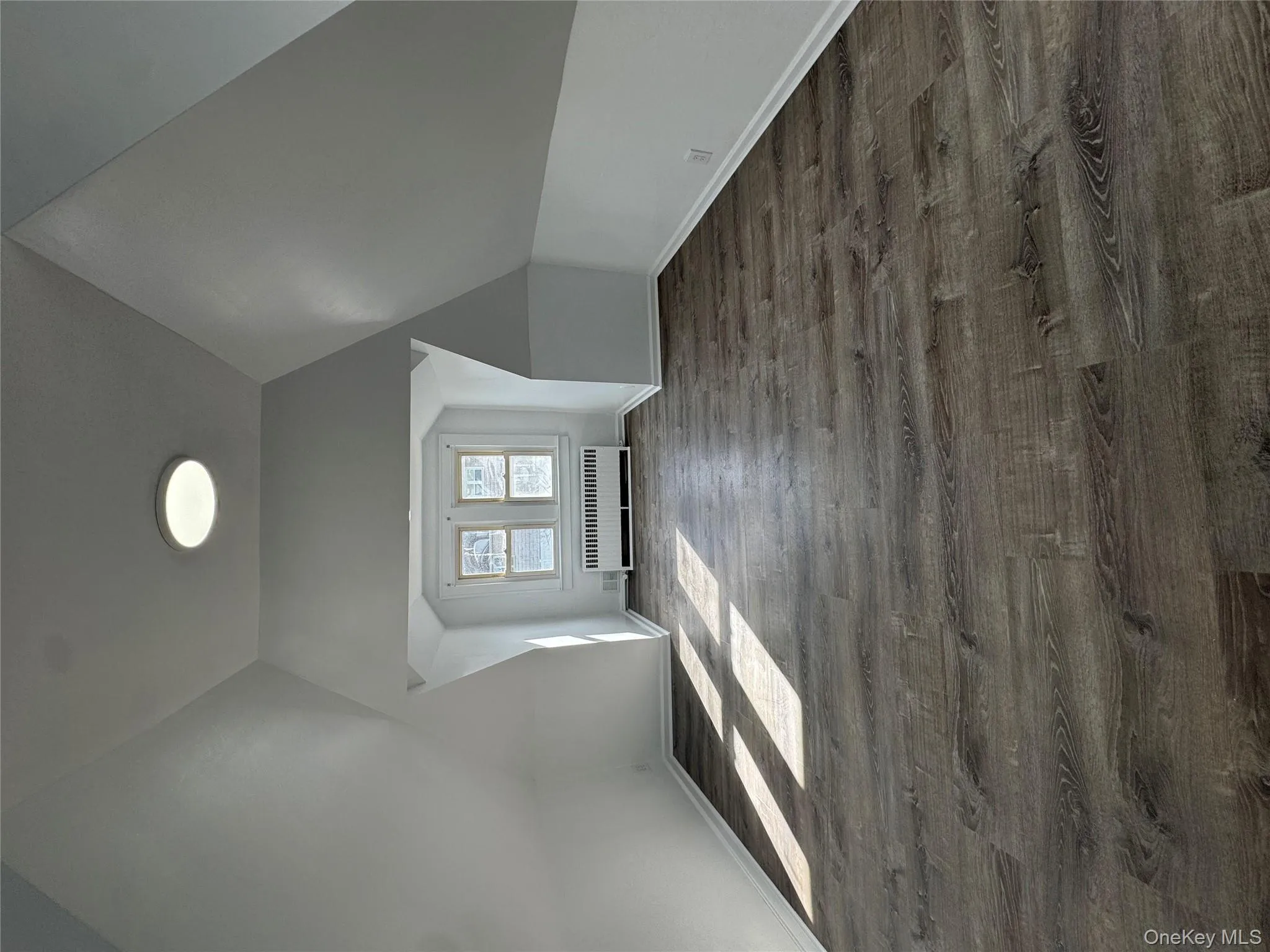 Bedroom with light wood-style flooring and vaulted ceiling Bedroom with light wood-style flooring and vaulted ceiling