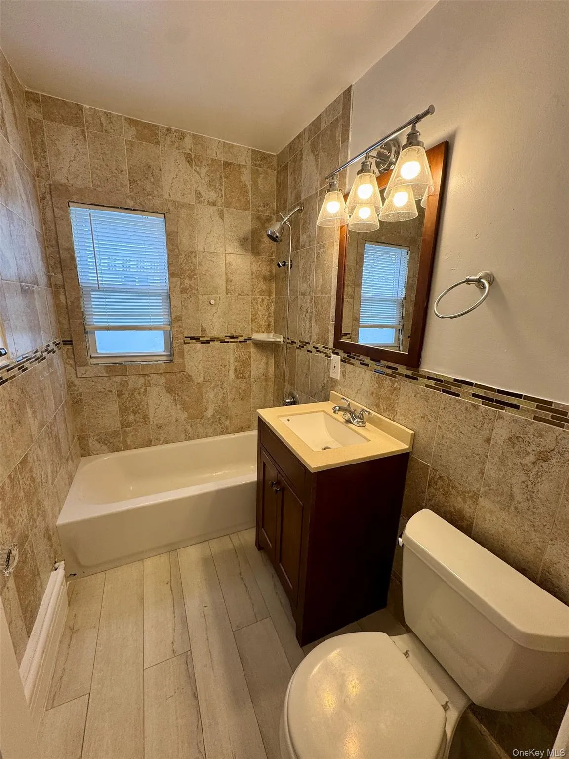 Bedroom with light wood-style flooring and vaulted ceiling Bedroom with light wood-style flooring and vaulted ceiling