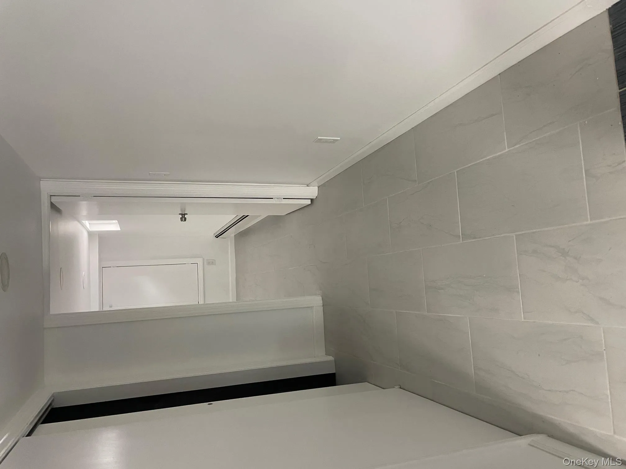 Corridor featuring baseboards and a baseboard radiator Corridor featuring baseboards and a baseboard radiator