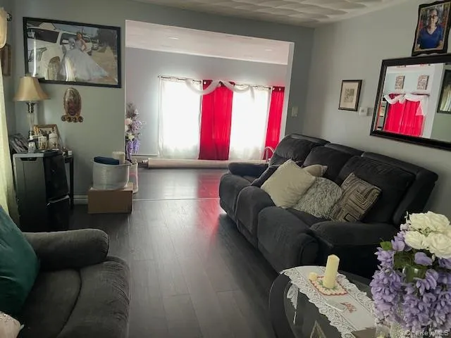 Living room featuring dark wood-style floors Living room featuring dark wood-style floors