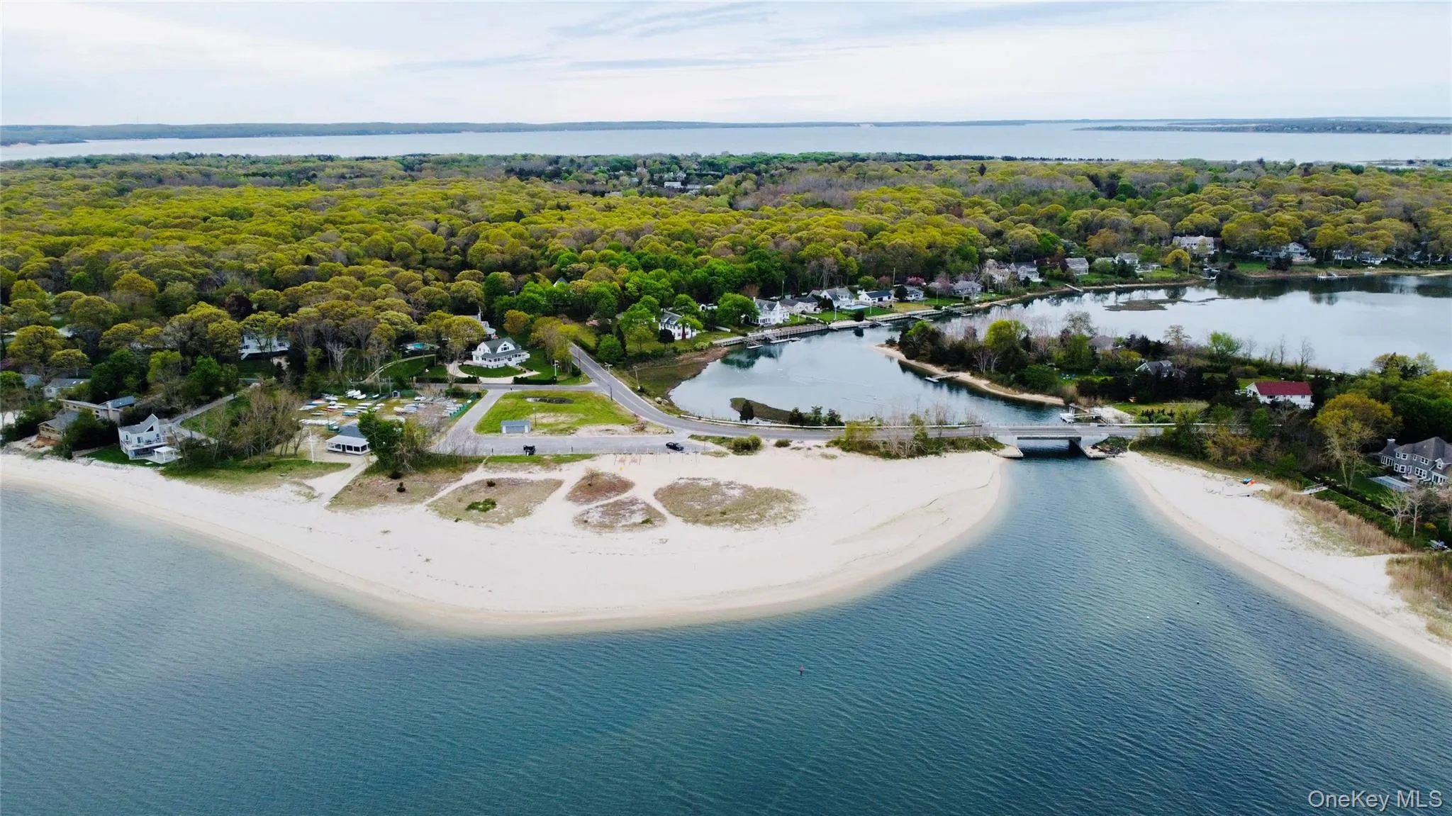 Drone / aerial view of a nearby body of water and a heavily wooded area Drone / aerial view of a nearby body of water and a heavily wooded area