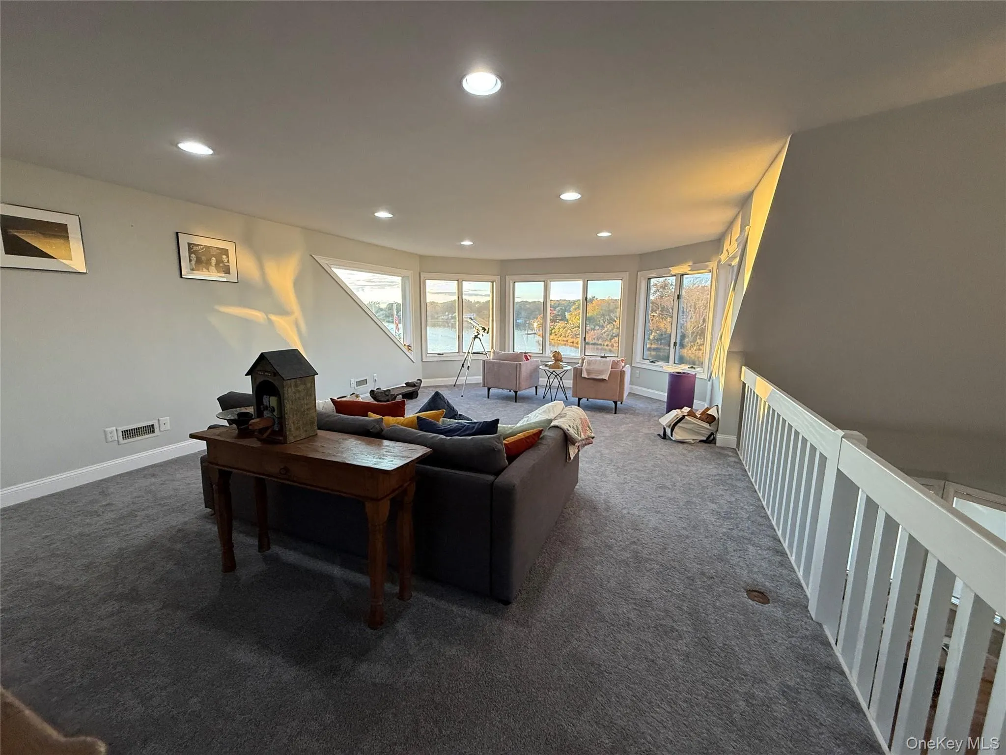 Living area featuring recessed lighting and dark carpet Living area featuring recessed lighting and dark carpet
