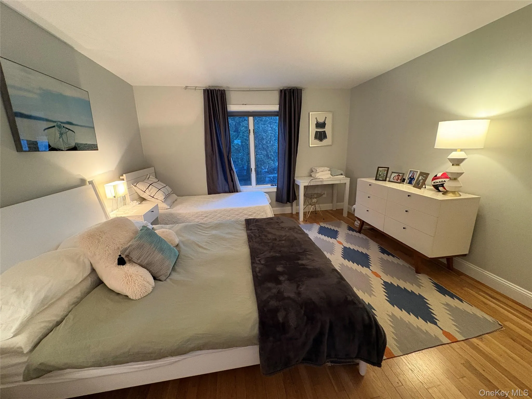 Bedroom with wood-type flooring and baseboards Bedroom with wood-type flooring and baseboards