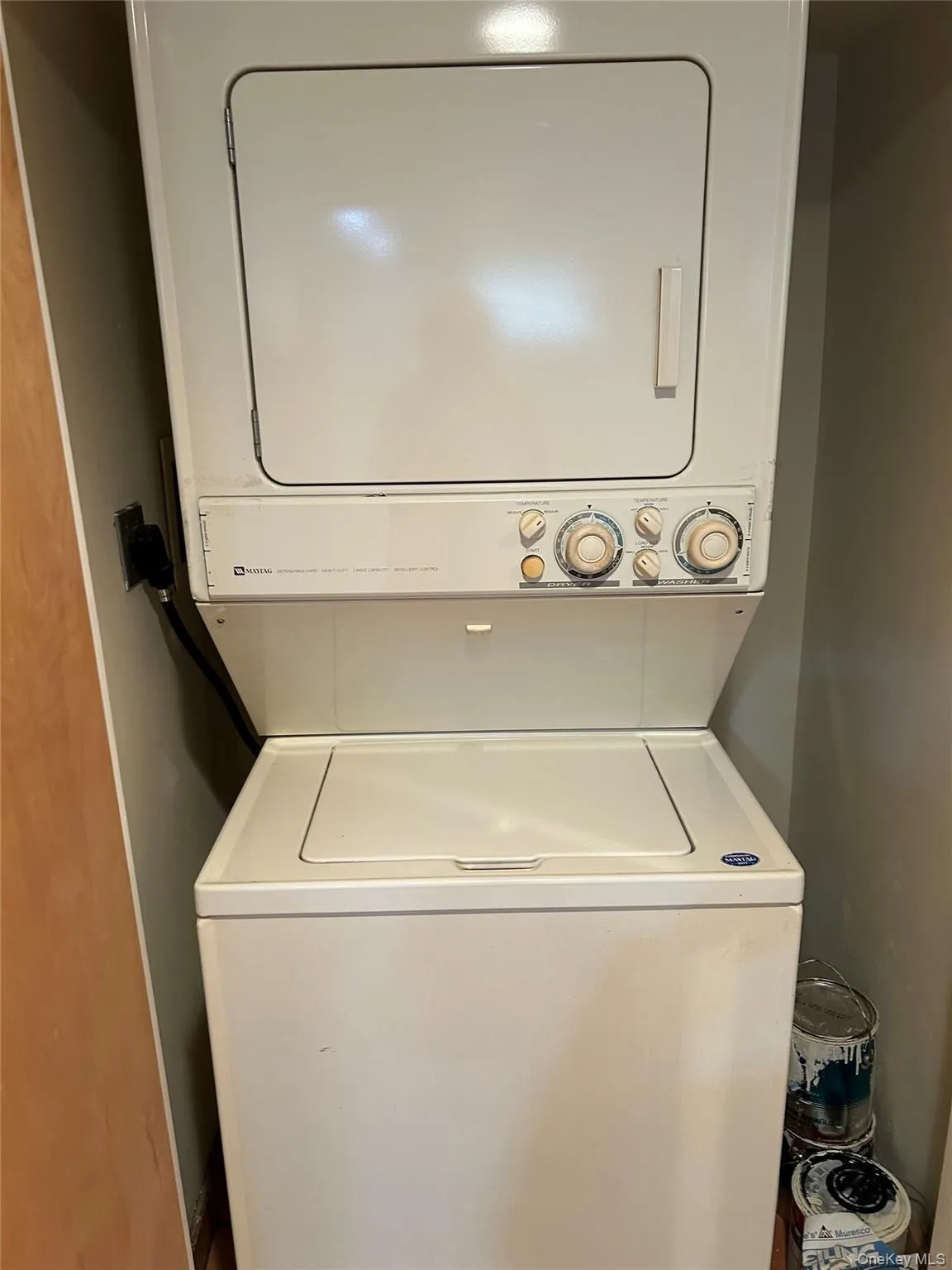 Washroom with stacked washing machine and dryer Washroom with stacked washing machine and dryer