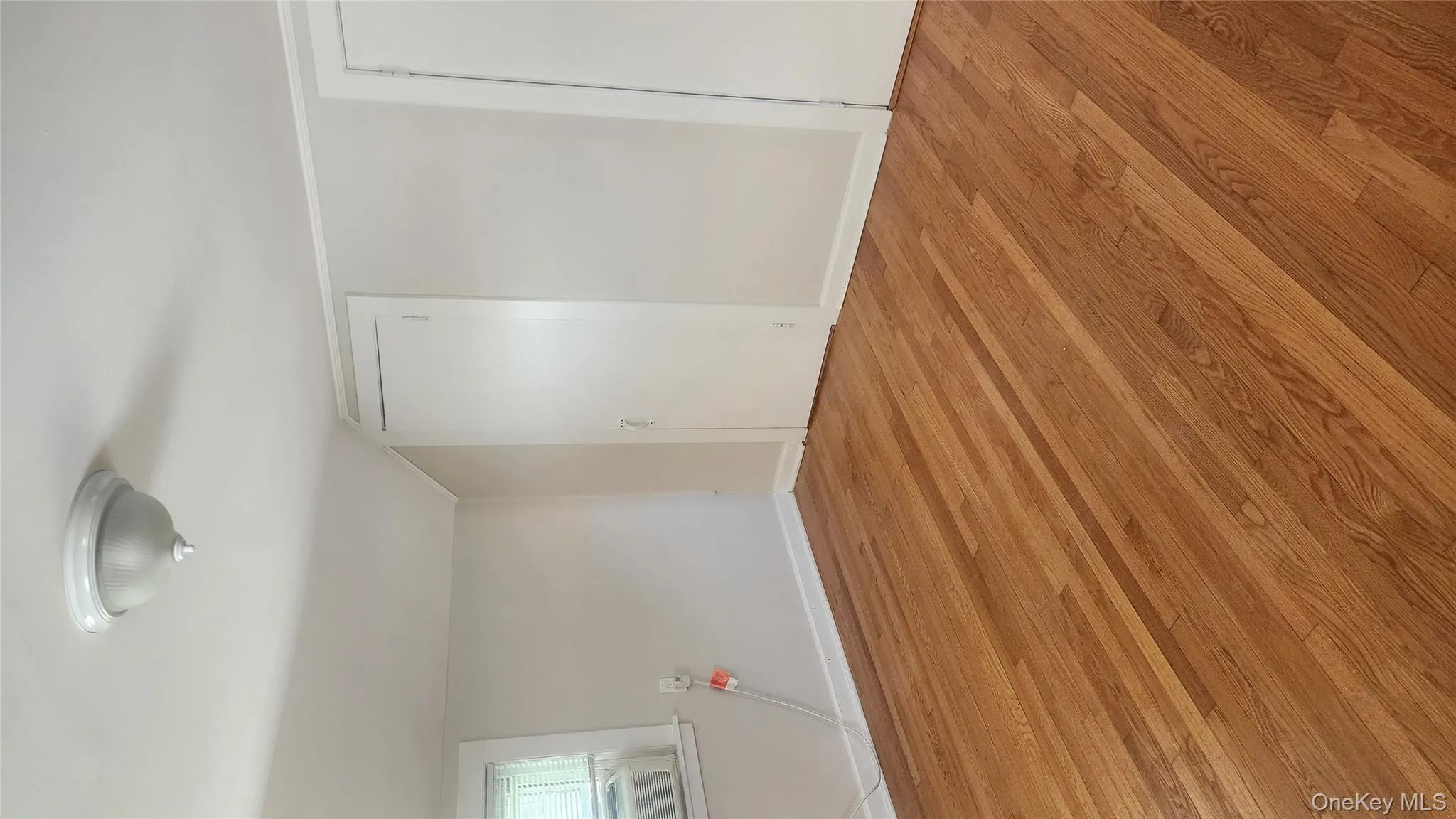 Empty room featuring light wood finished floors and lofted ceiling Empty room featuring light wood finished floors and lofted ceiling