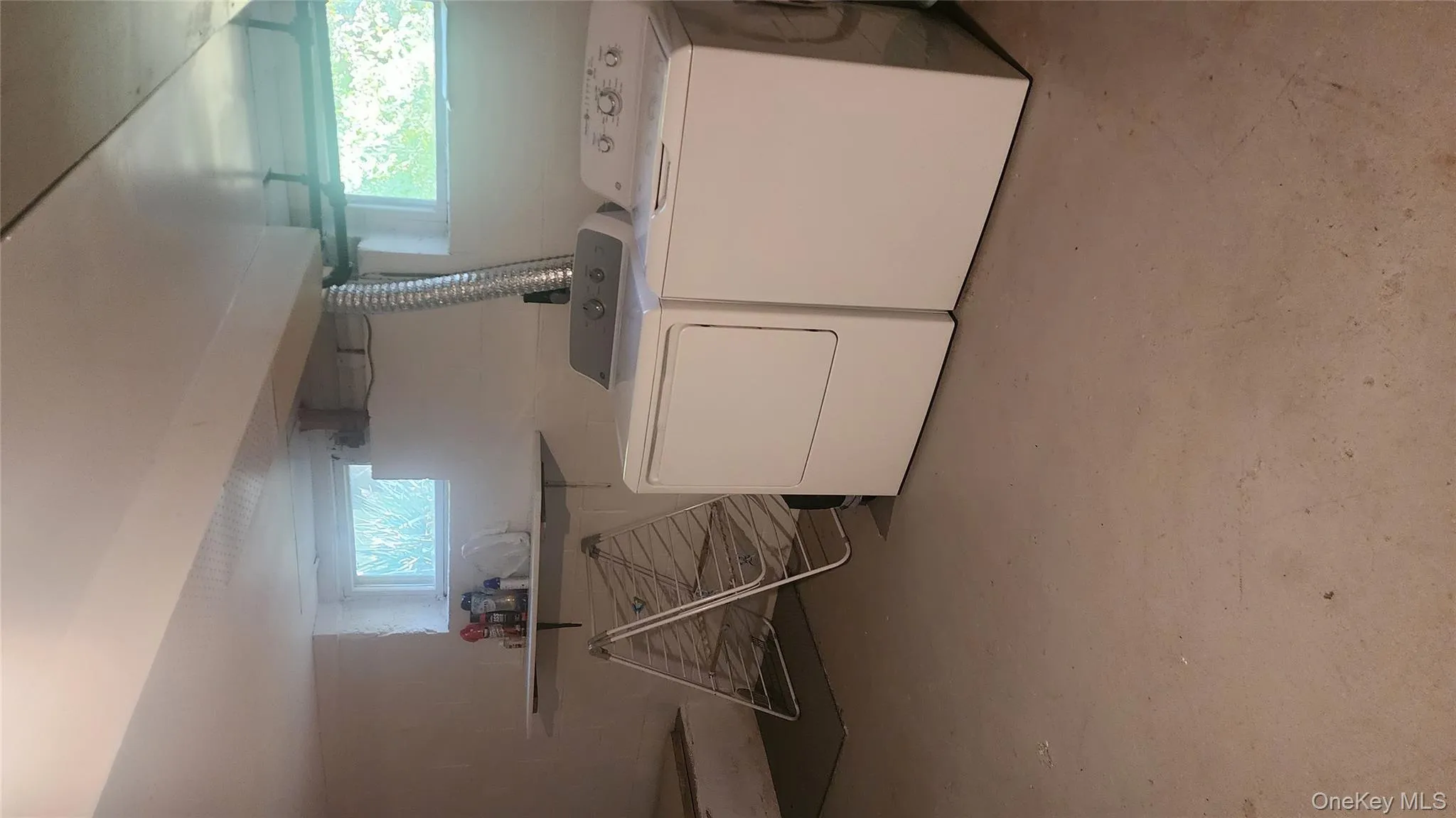 Laundry area with concrete floors and independent washer and dryer Laundry area with concrete floors and independent washer and dryer