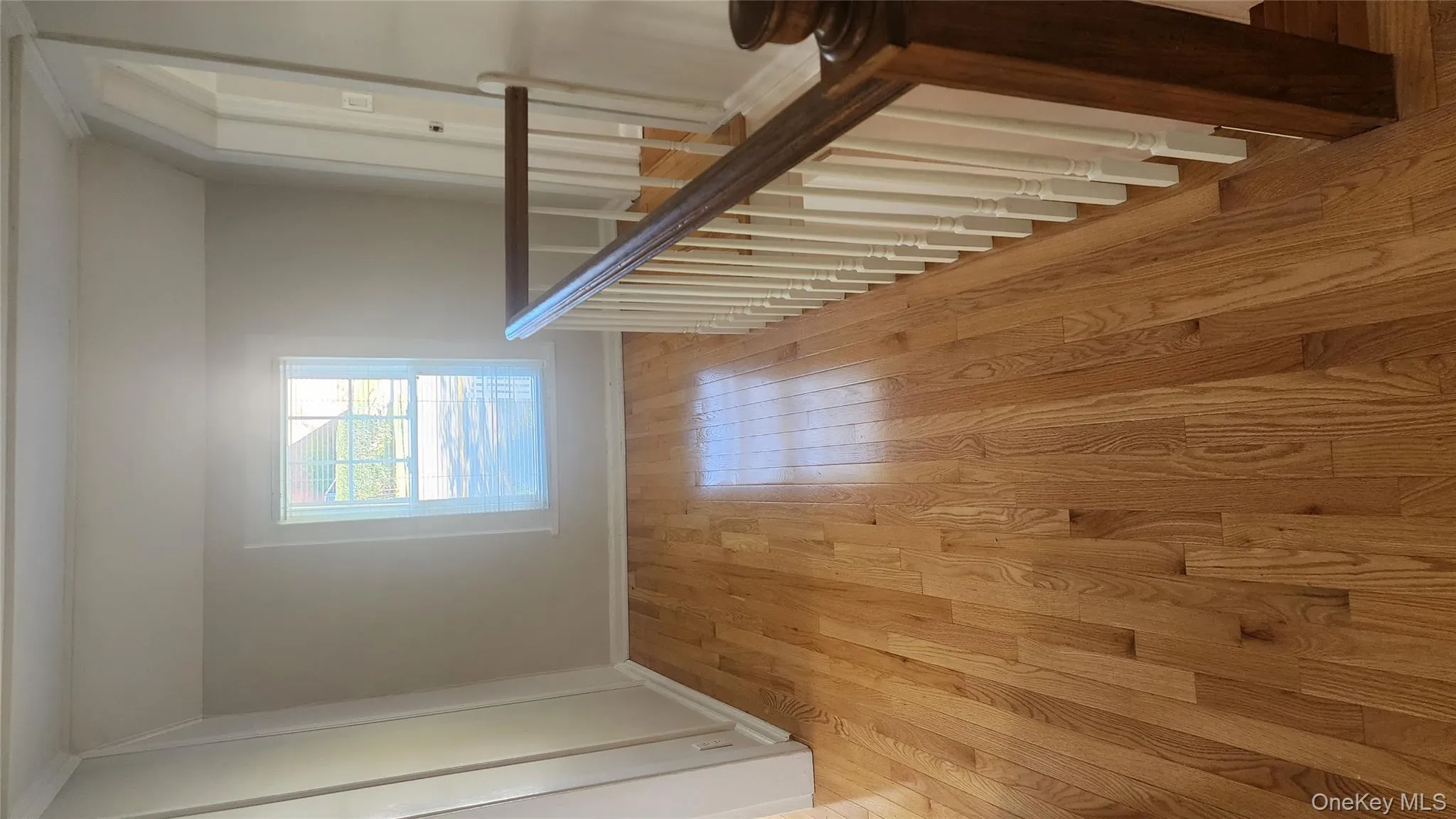 Corridor featuring light wood-style flooring and vaulted ceiling Corridor featuring light wood-style flooring and vaulted ceiling