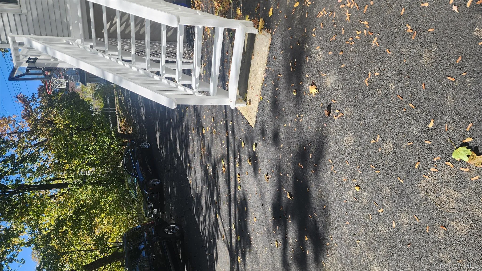 View of parking featuring stairway View of parking featuring stairway
