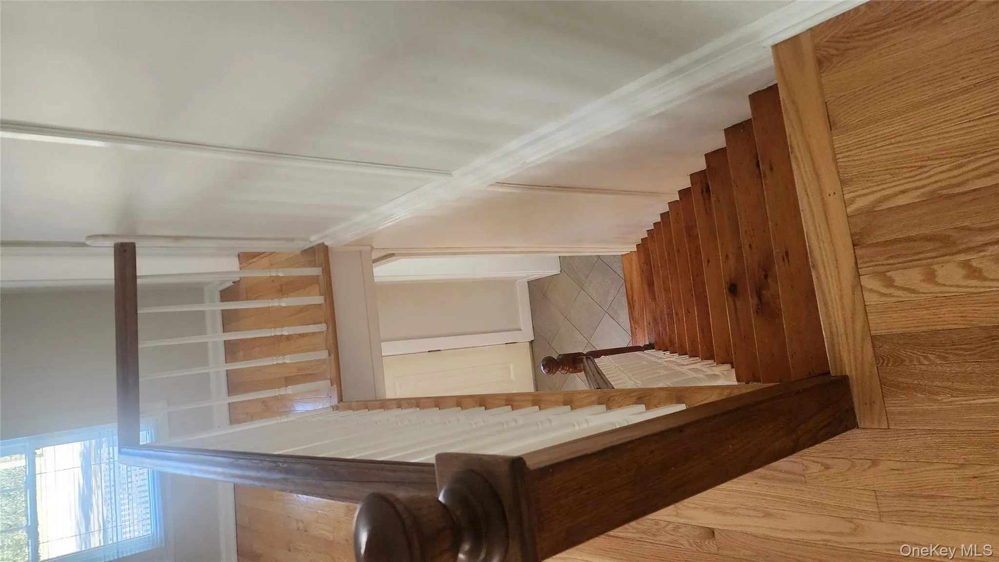 Staircase with hardwood / wood-style floors and baseboards Staircase with hardwood / wood-style floors and baseboards