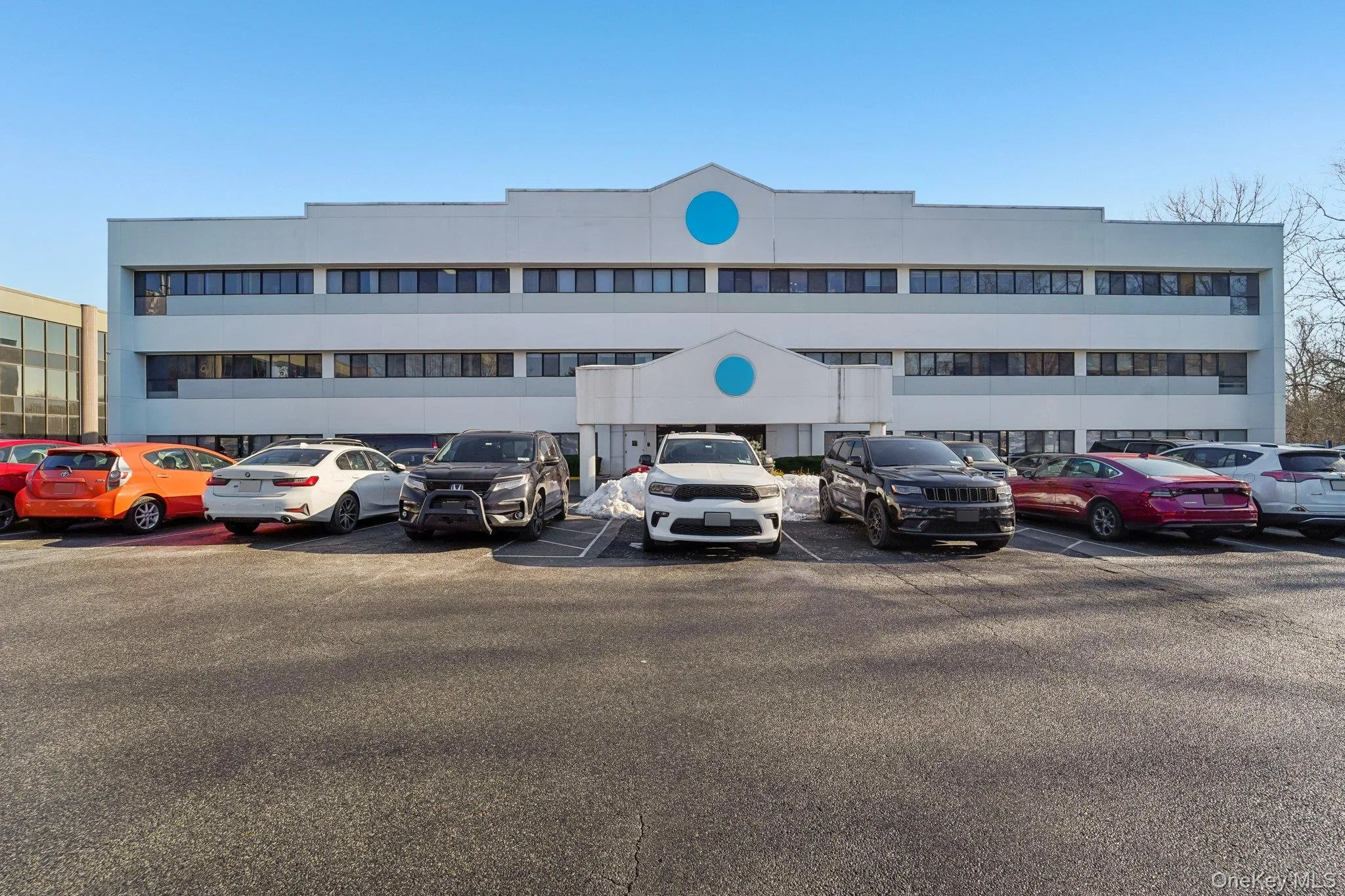View of apartment building / complex featuring uncovered parking View of apartment building / complex featuring uncovered parking