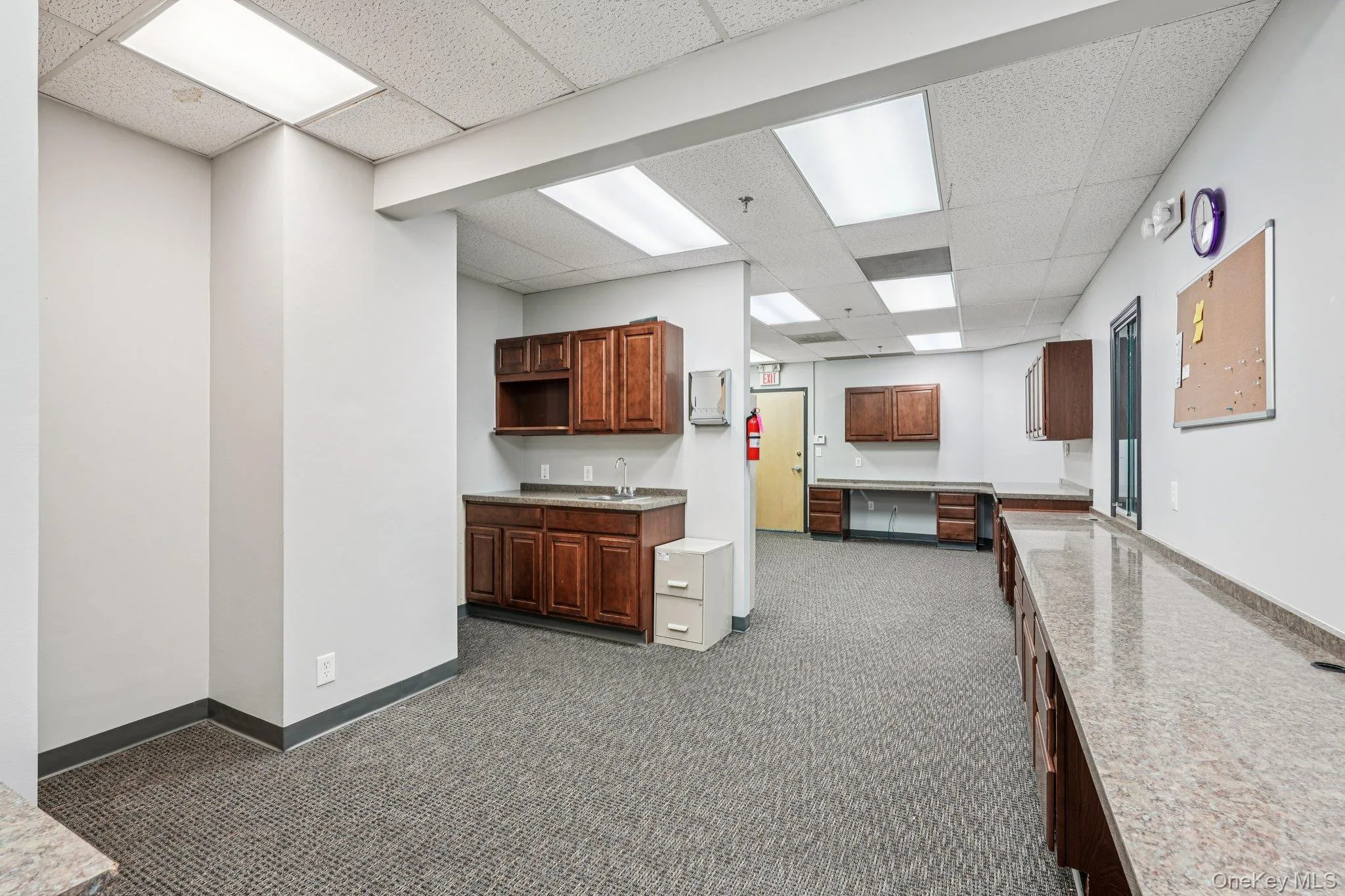 Kitchen featuring a paneled ceiling and a sink Kitchen featuring a paneled ceiling and a sink