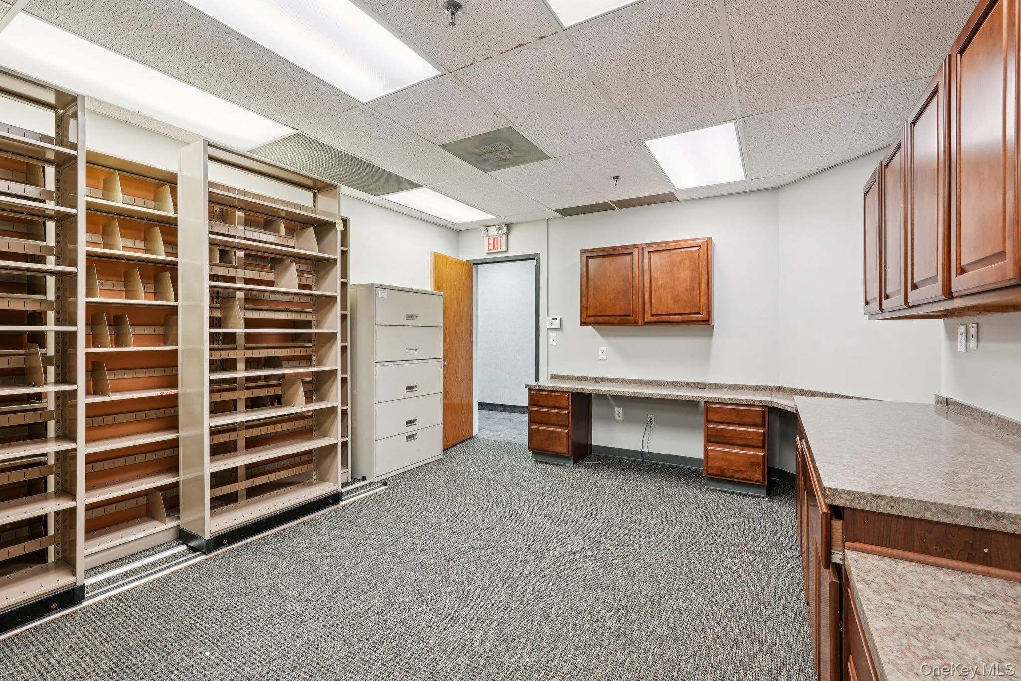 Unfurnished office featuring a paneled ceiling and built in study area Unfurnished office featuring a paneled ceiling and built in study area