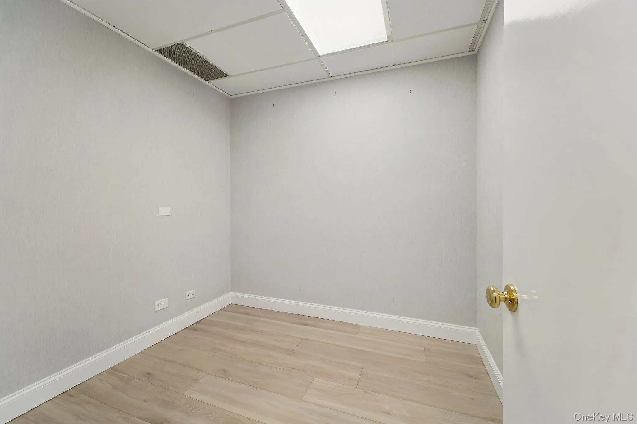 Empty room featuring light wood-style flooring and baseboards Empty room featuring light wood-style flooring and baseboards