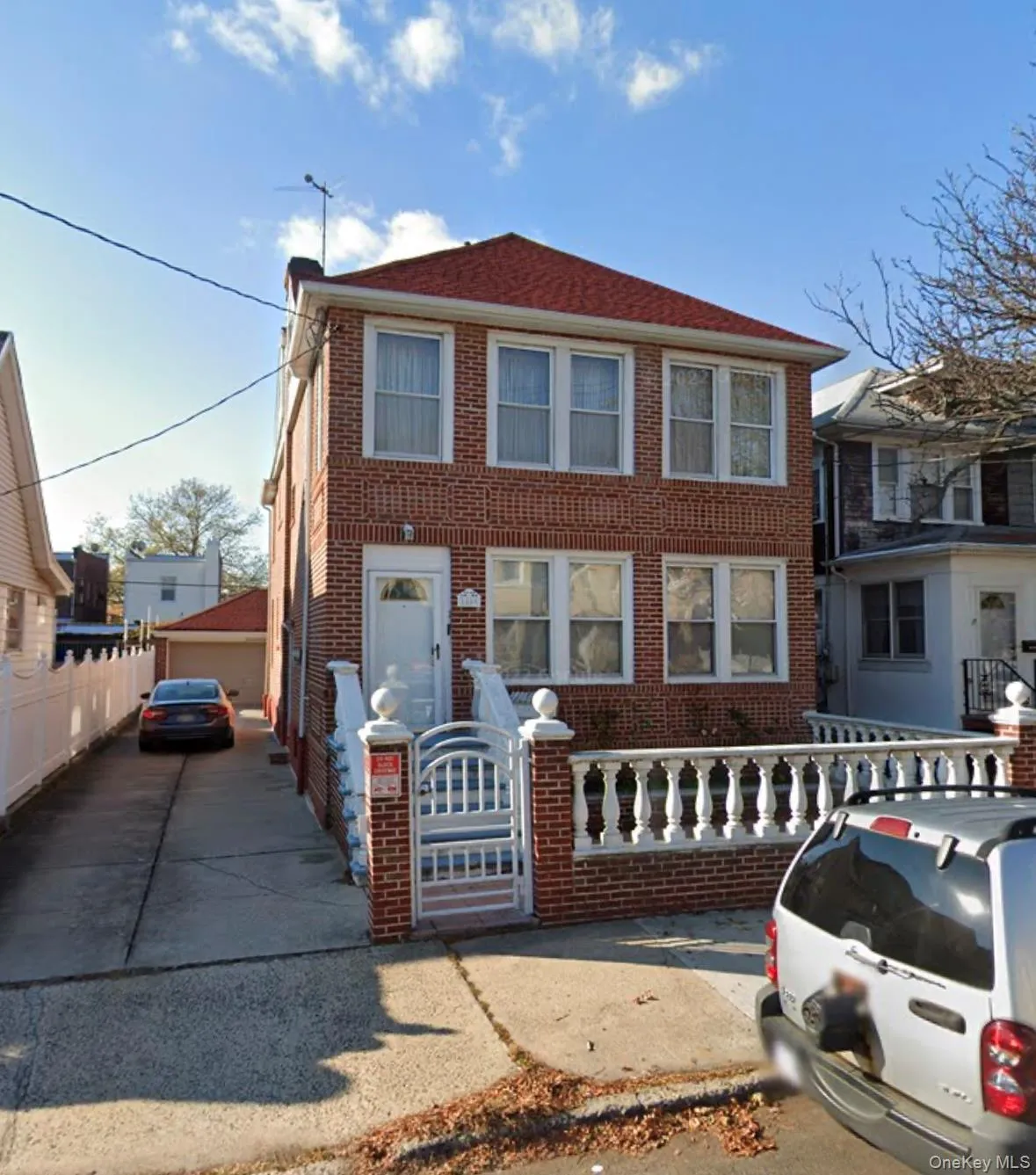 View of front facade featuring a fenced front yard and brick siding View of front facade featuring a fenced front yard and brick siding