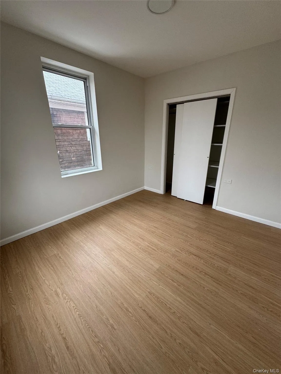 Unfurnished bedroom with light wood-style floors and a closet Unfurnished bedroom with light wood-style floors and a closet