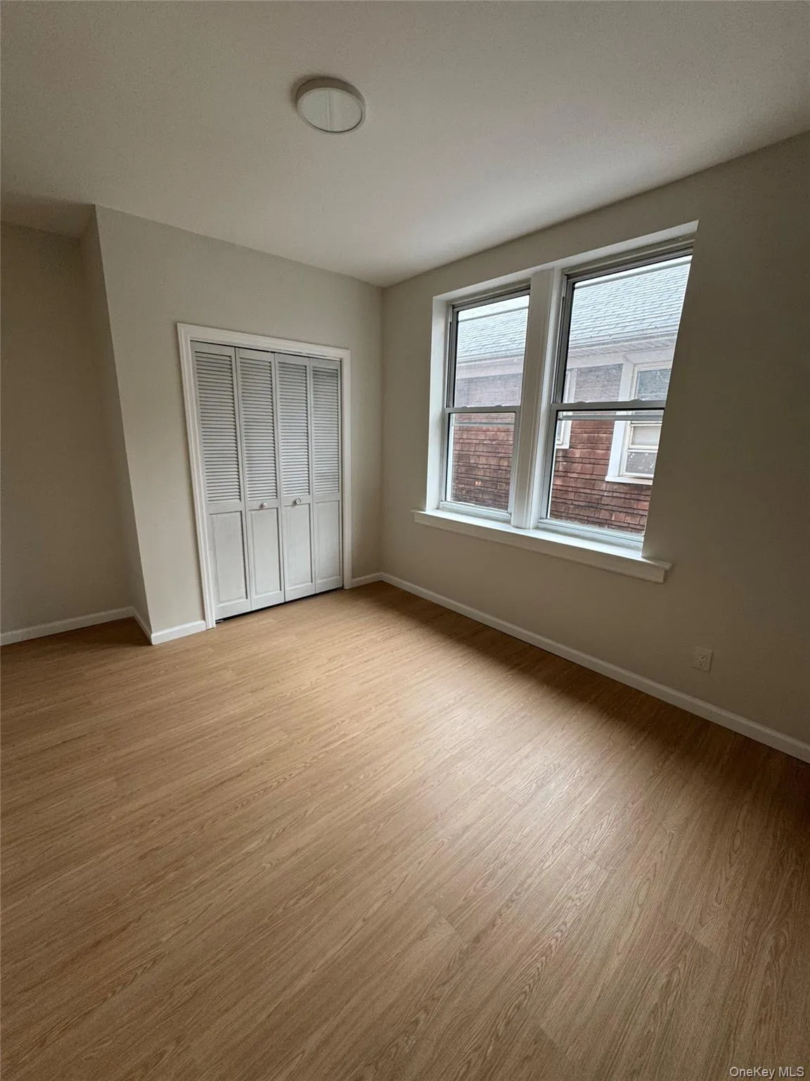 Unfurnished bedroom featuring light wood-style flooring and a closet Unfurnished bedroom featuring light wood-style flooring and a closet