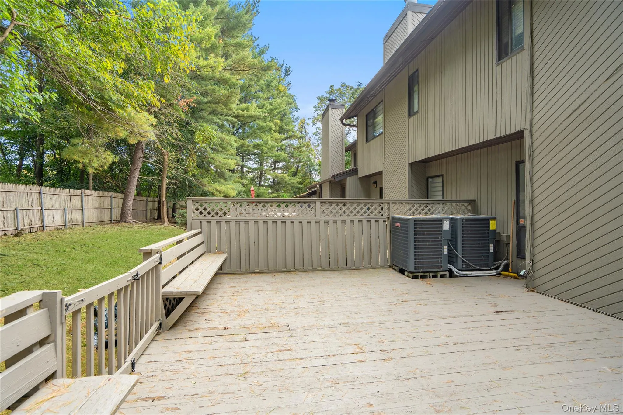 Wooden terrace featuring a fenced backyard Wooden terrace featuring a fenced backyard