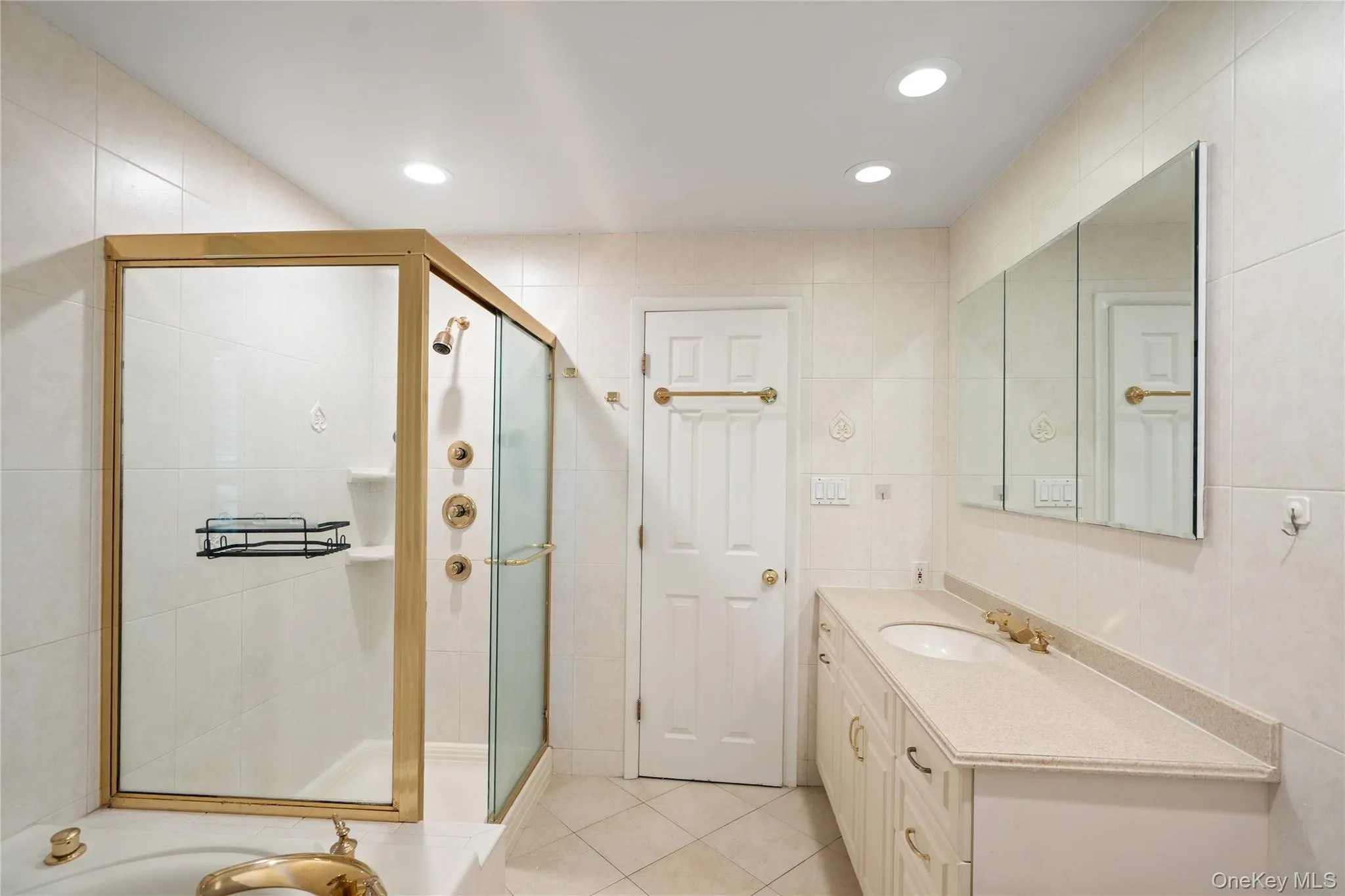 Full bathroom featuring vanity, tile walls, recessed lighting, a tub, and a shower stall Full bathroom featuring vanity, tile walls, recessed lighting, a tub, and a shower stall