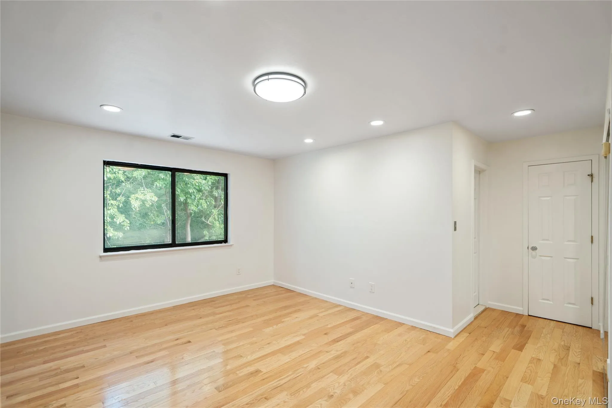 Spare room with light wood-type flooring and recessed lighting Spare room with light wood-type flooring and recessed lighting