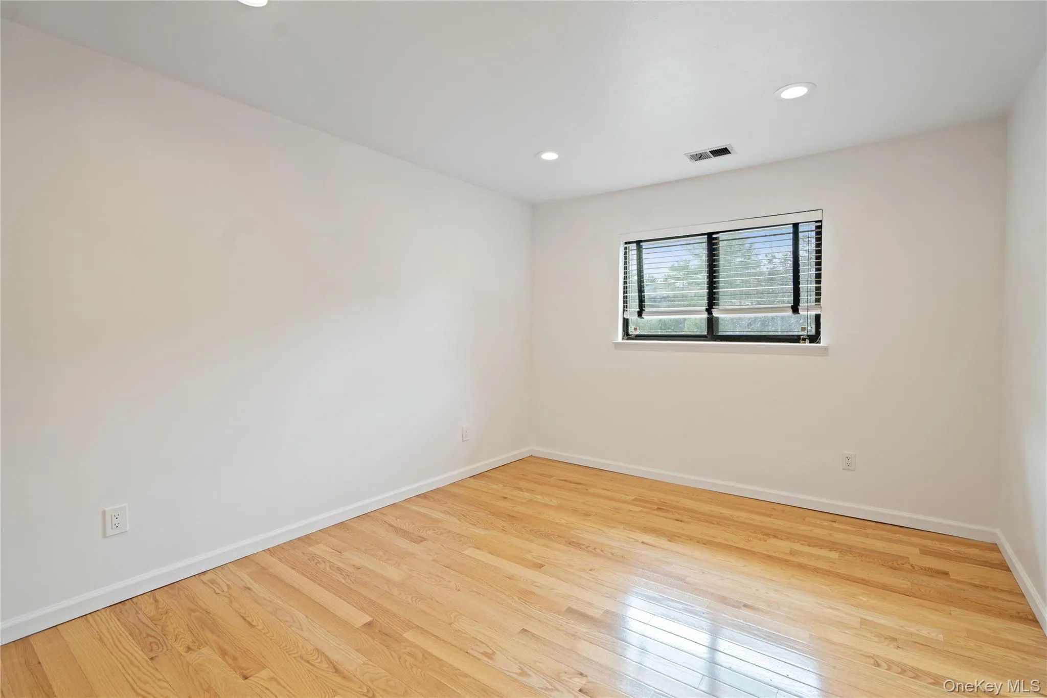 Spare room with light wood-style floors and recessed lighting Spare room with light wood-style floors and recessed lighting