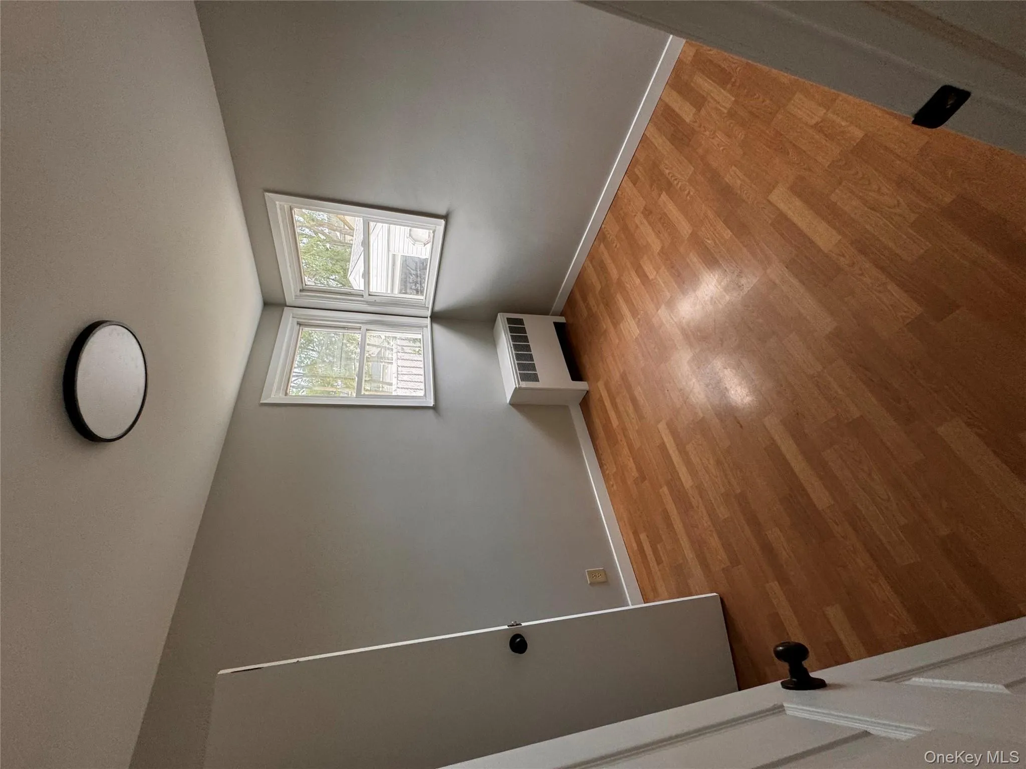 Spare room with radiator and light wood-style flooring Spare room with radiator and light wood-style flooring