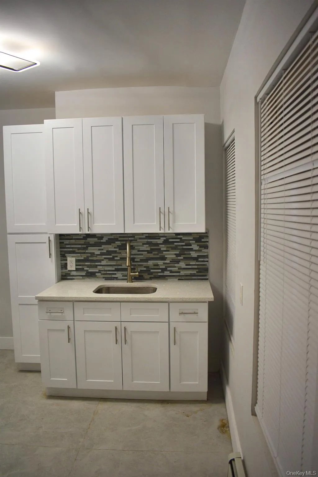 Bathroom featuring vanity and decorative backsplash Bathroom featuring vanity and decorative backsplash