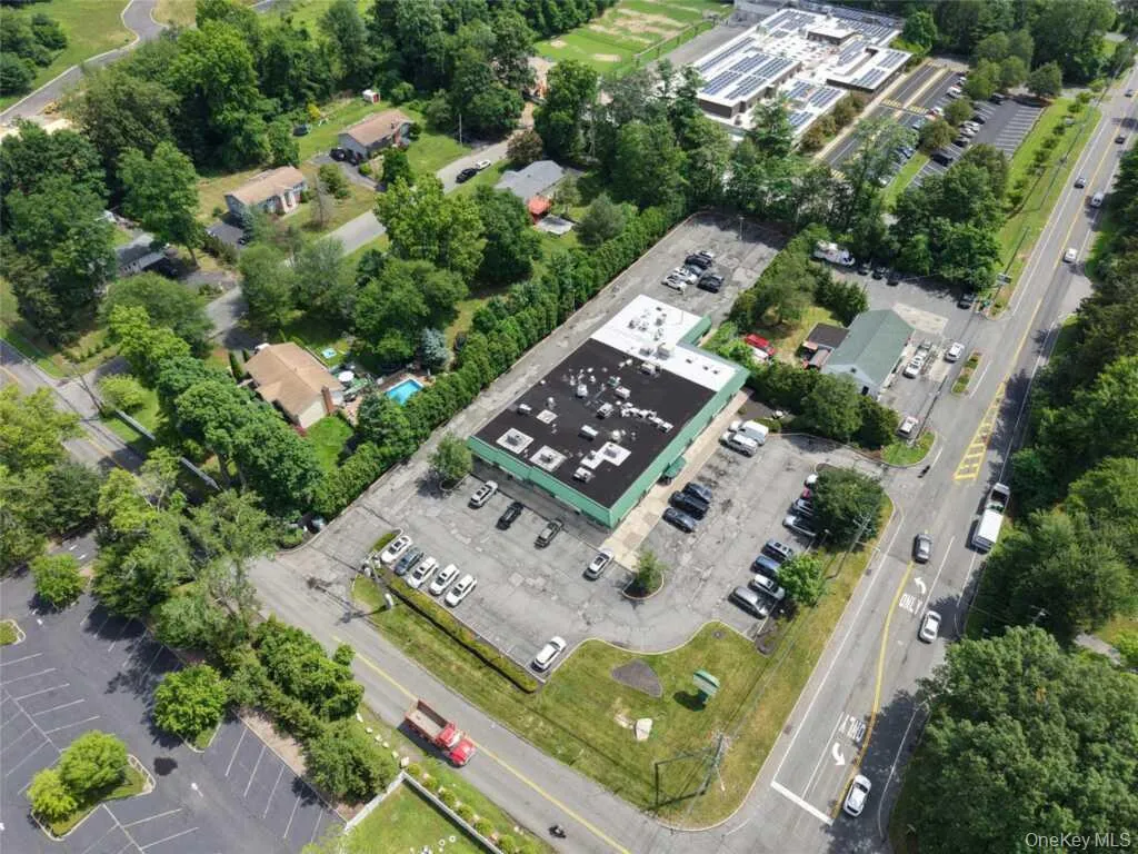 Aerial view of property and surrounding area featuring a tree filled landscape Aerial view of property and surrounding area featuring a tree filled landscape