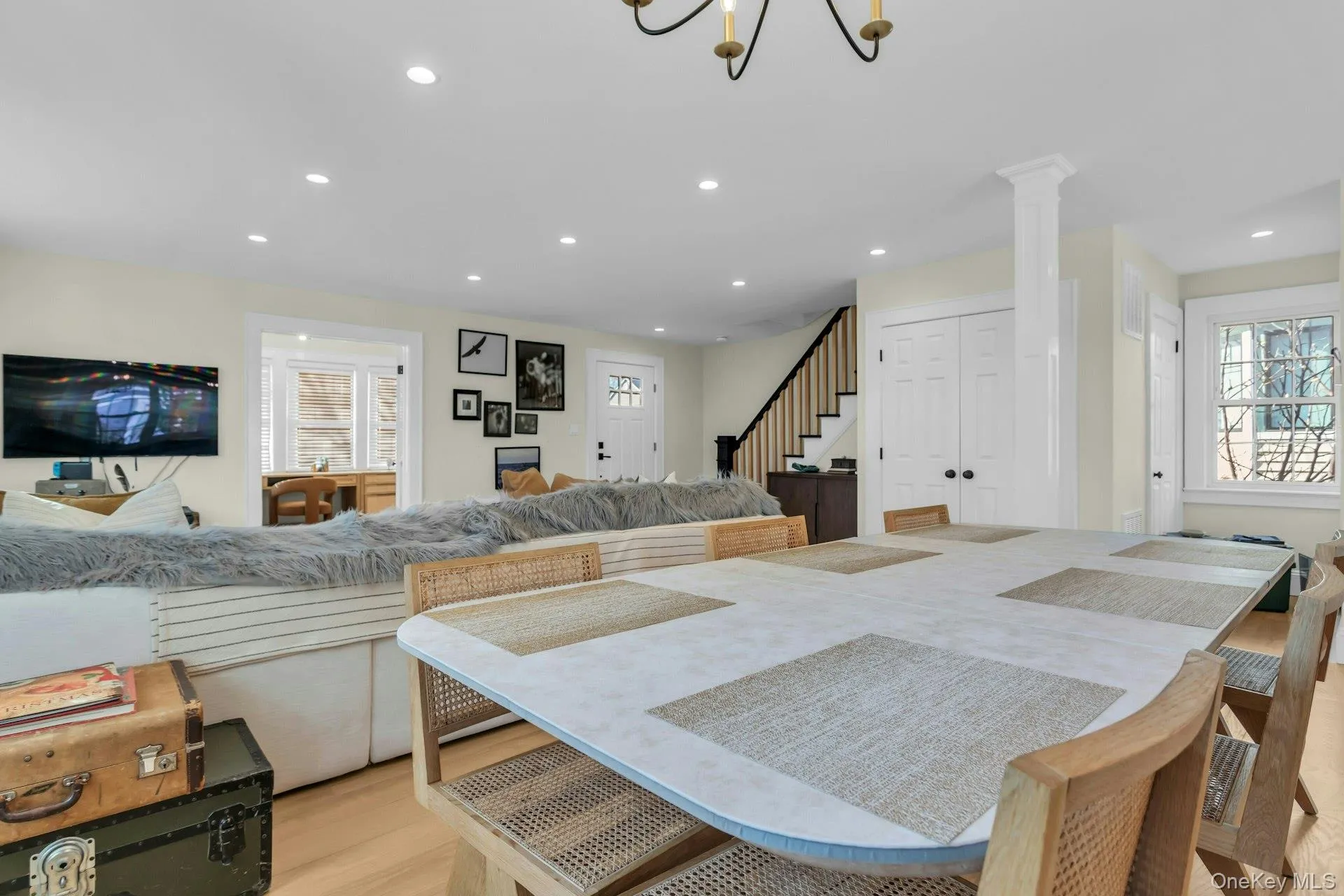 Dining space featuring light wood-style floors, plenty of natural light, recessed lighting, and stairway Dining space featuring light wood-style floors, plenty of natural light, recessed lighting, and stairway
