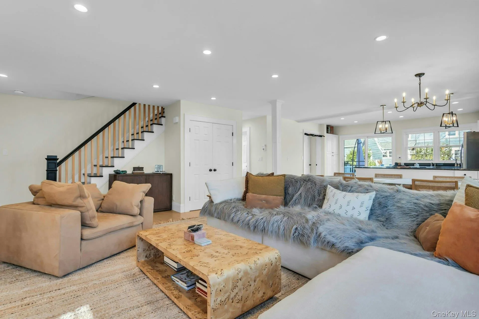 Living area featuring recessed lighting, stairs, and a chandelier Living area featuring recessed lighting, stairs, and a chandelier