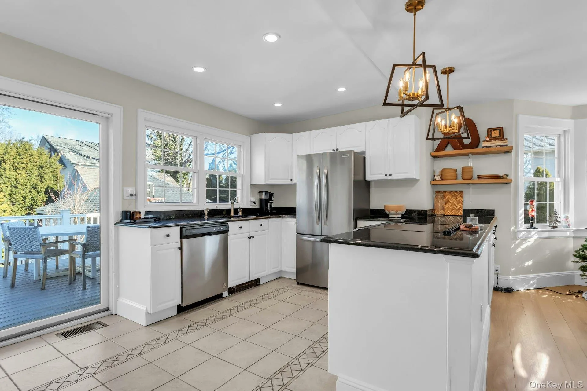 Kitchen with white cabinetry, pendant lighting, stainless steel appliances, healthy amount of natural light, and recessed lighting Kitchen with white cabinetry, pendant lighting, stainless steel appliances, healthy amount of natural light, and recessed lighting