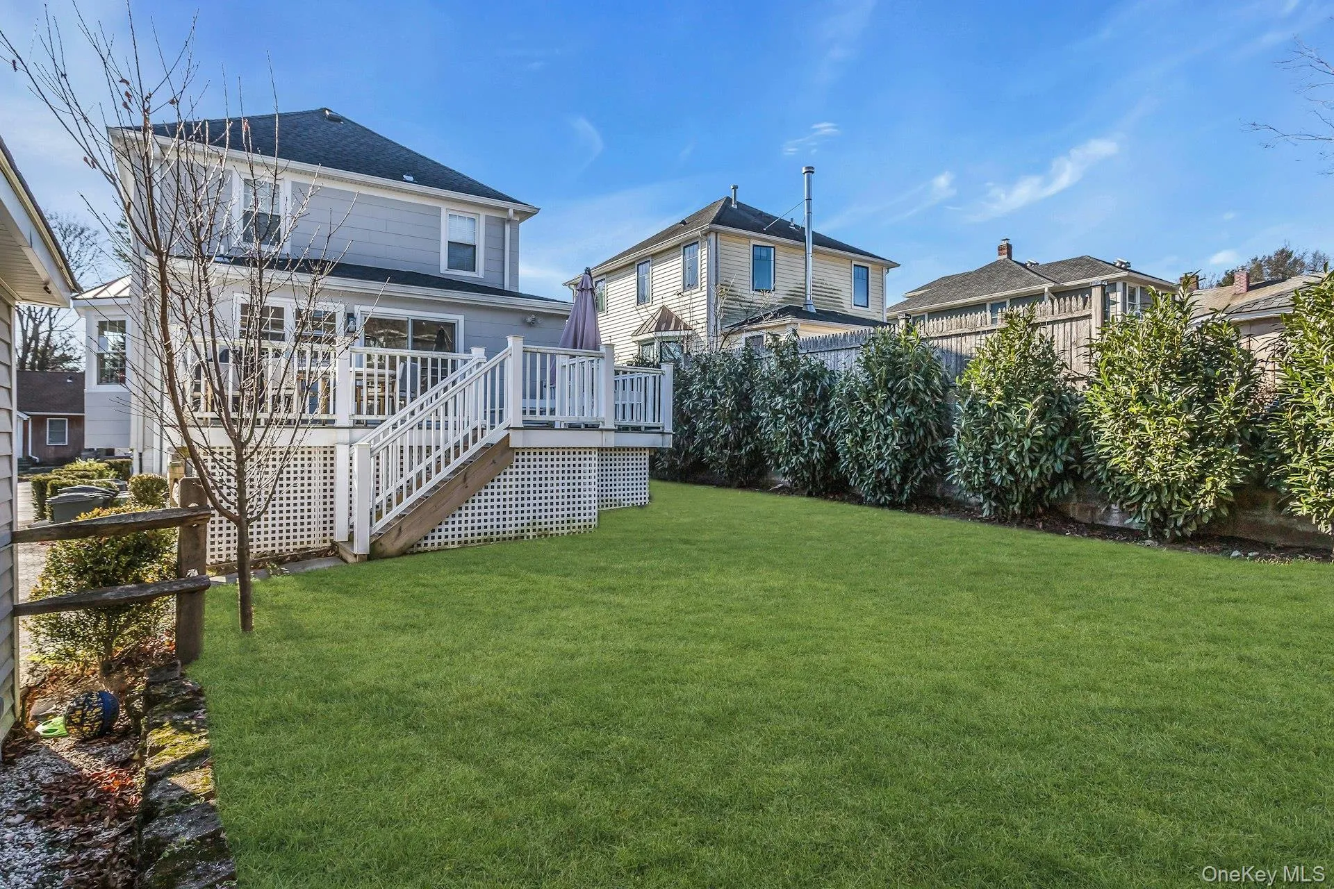 Back of property featuring a fenced backyard, stairs, and a deck Back of property featuring a fenced backyard, stairs, and a deck