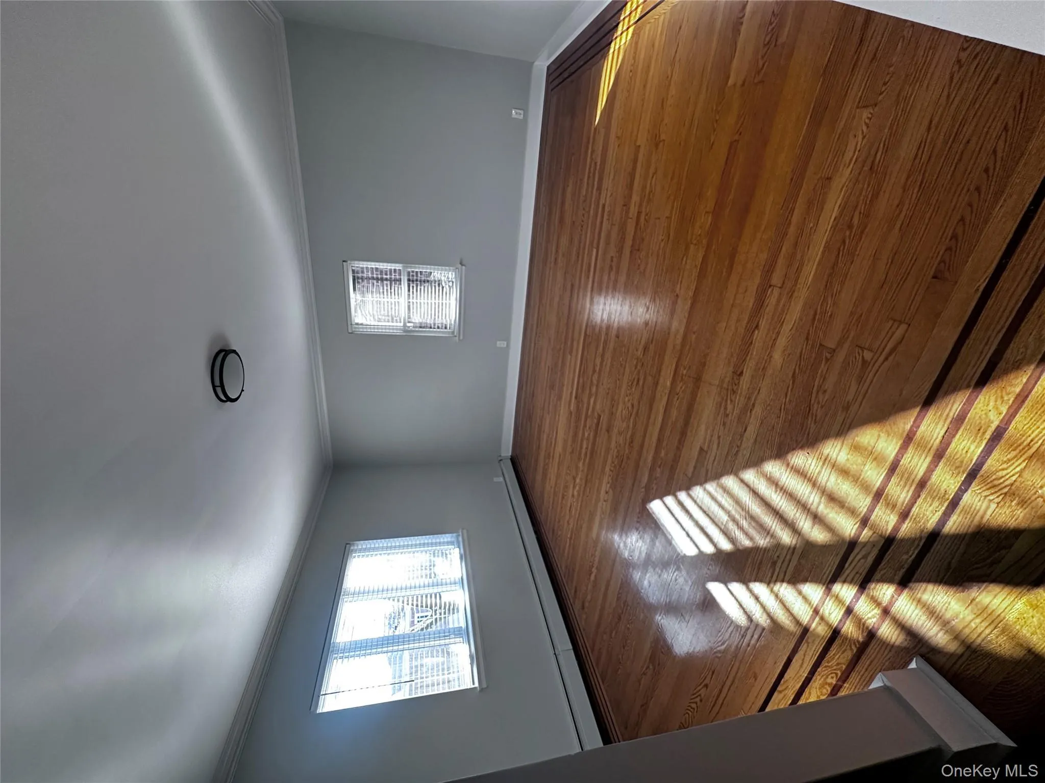 Unfurnished room with a baseboard radiator, hardwood / wood-style floors, and ornamental molding Unfurnished room with a baseboard radiator, hardwood / wood-style floors, and ornamental molding