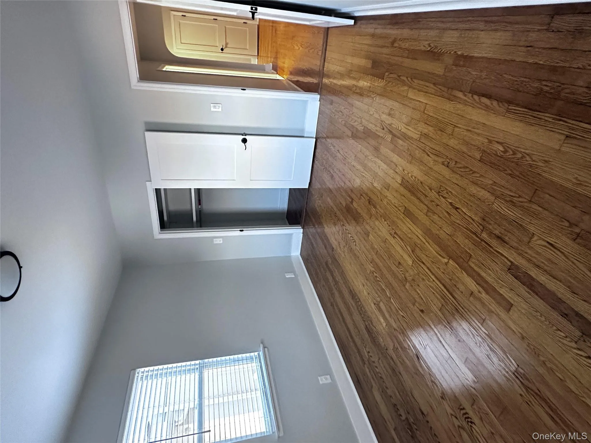 Unfurnished bedroom with dark wood-style floors and a closet Unfurnished bedroom with dark wood-style floors and a closet