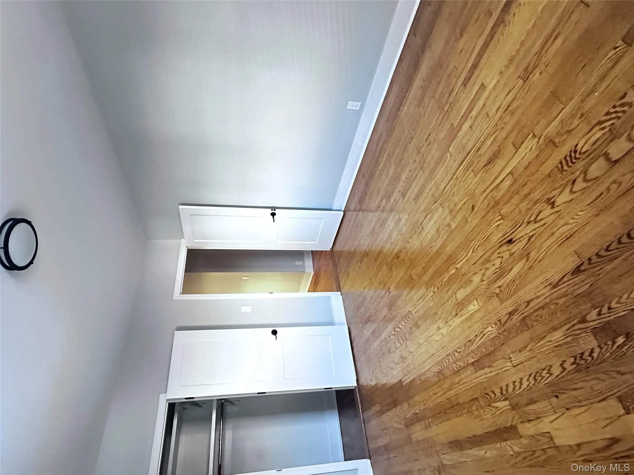 Unfurnished bedroom featuring light wood-style flooring and a closet Unfurnished bedroom featuring light wood-style flooring and a closet