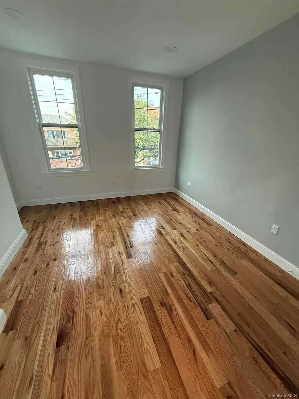 Empty room with wood finished floors and baseboards Empty room with wood finished floors and baseboards