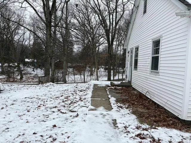 View of yard layered in snow View of yard layered in snow