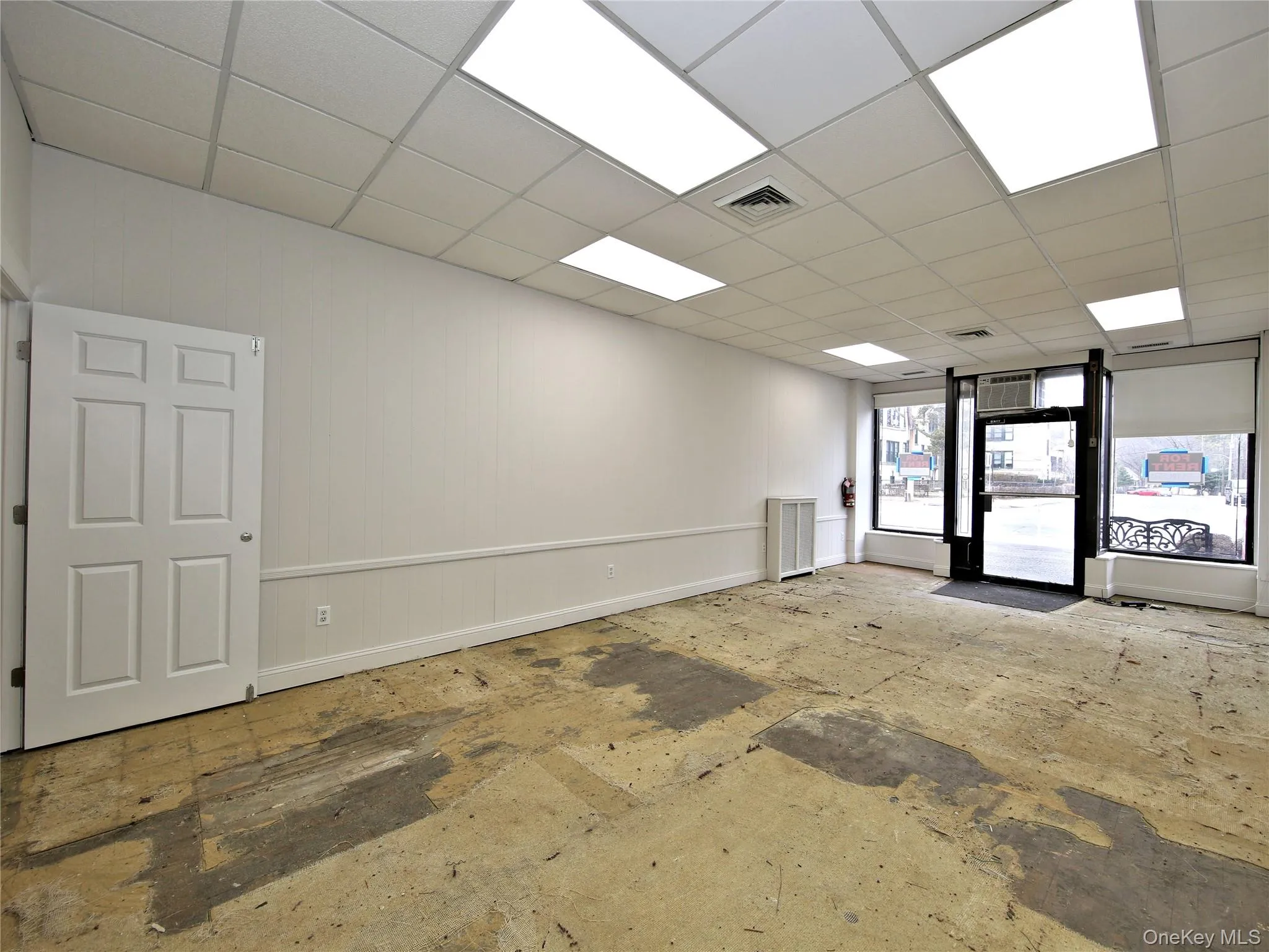 Unfurnished room featuring baseboards and a paneled ceiling Unfurnished room featuring baseboards and a paneled ceiling